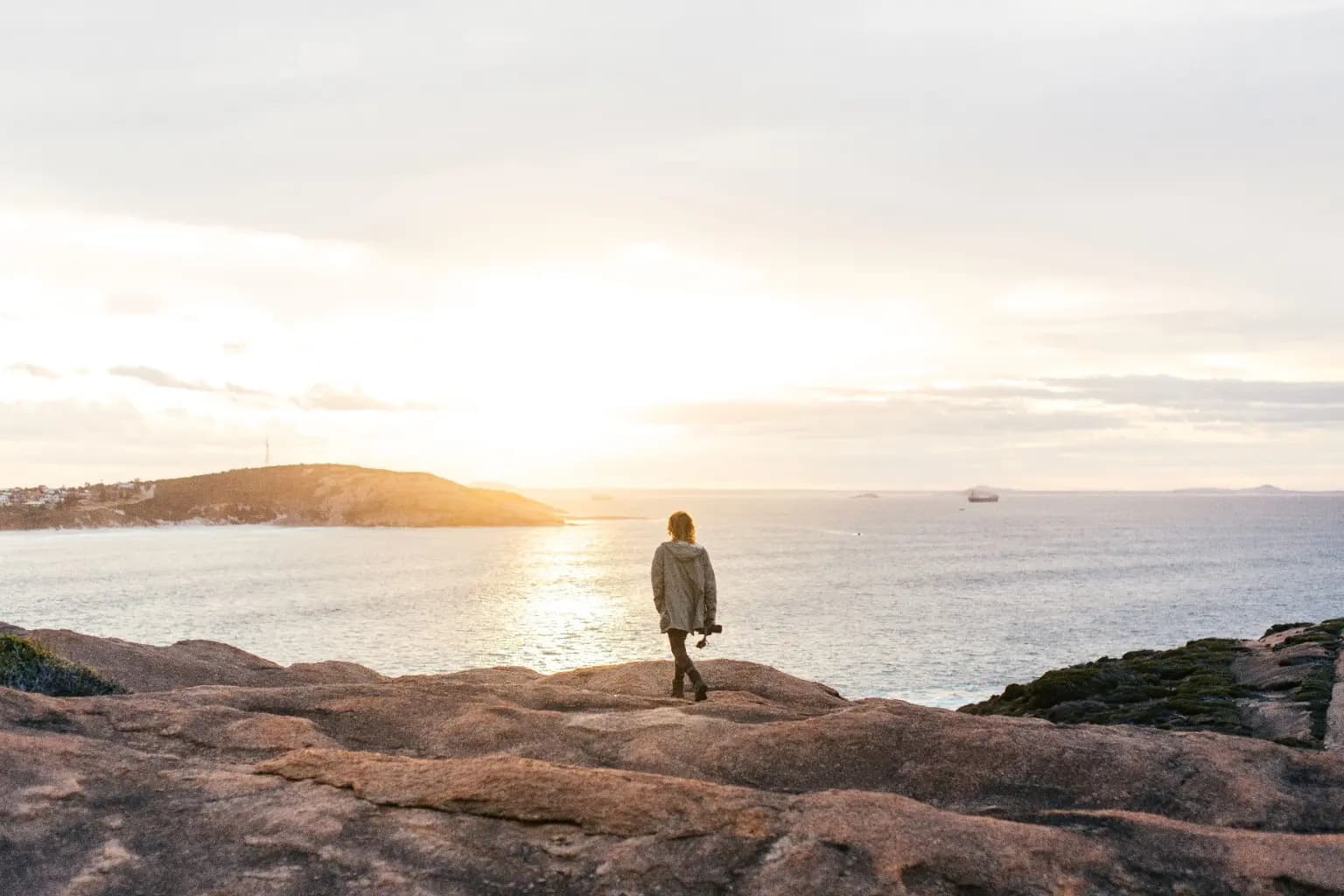 A traveller exploring a rocky coastline