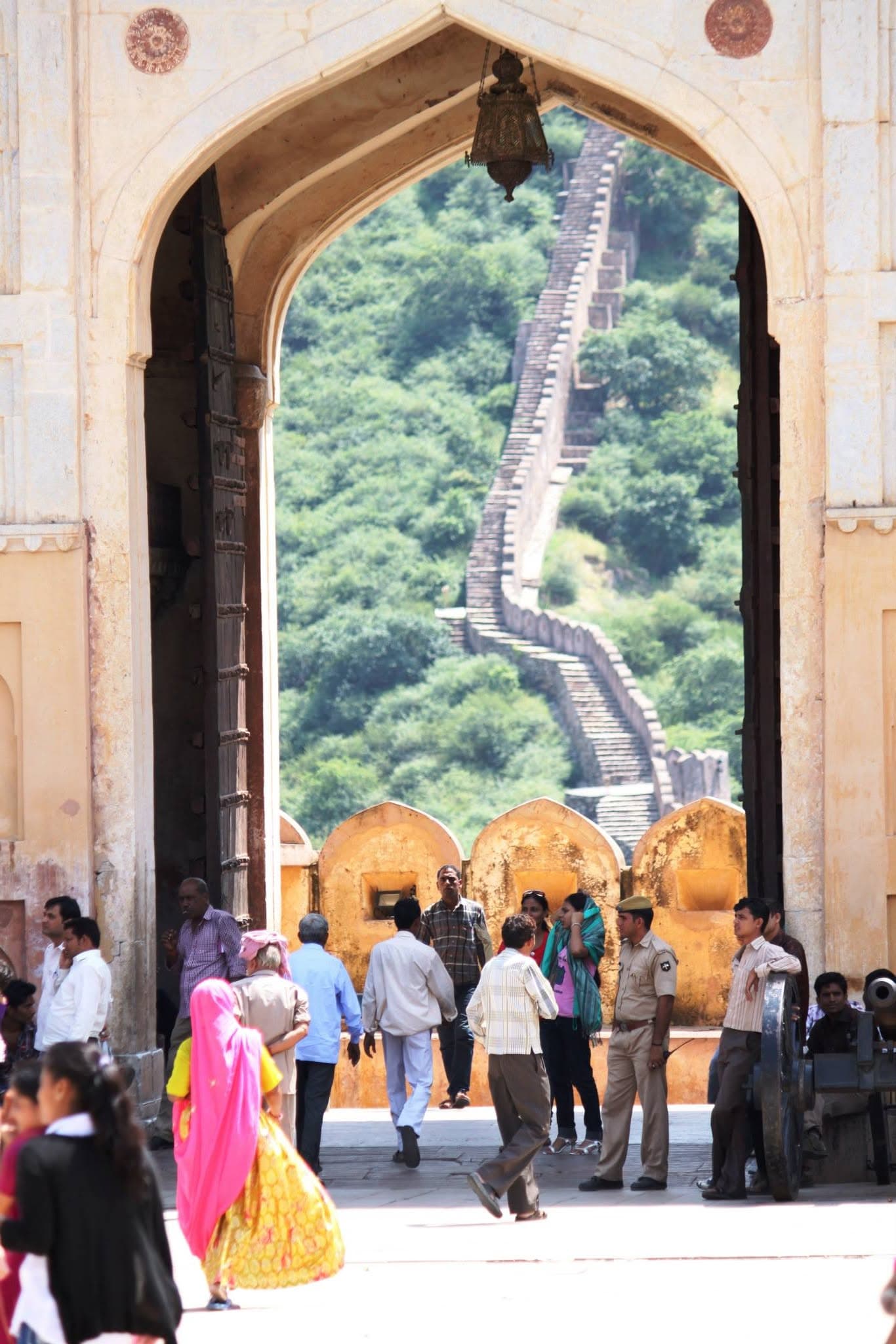 Visitors walking through an archway at Amber Fort in Jaipur