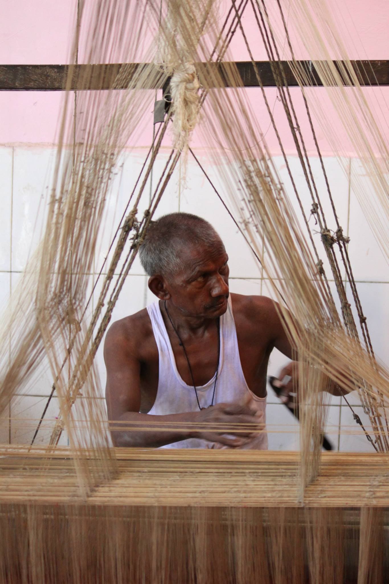 A weaver working at a loom in Delhi, photographed during the India trip